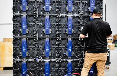LED display wall being tested by LED technician